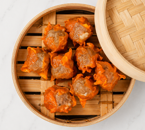 RTK Chicken Siomai served in an open bamboo steamer basket.