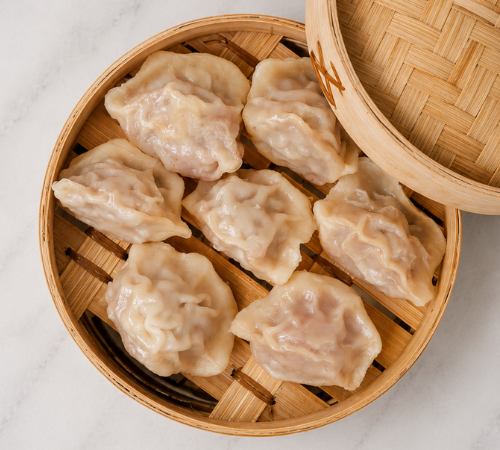 RTK Gyoza Dumpling served in an open bamboo steamer basket.