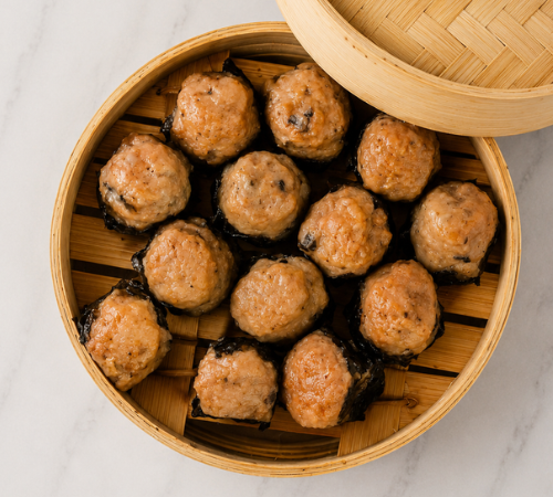 RTK Japanese Siomai served in an open bamboo steamer basket.