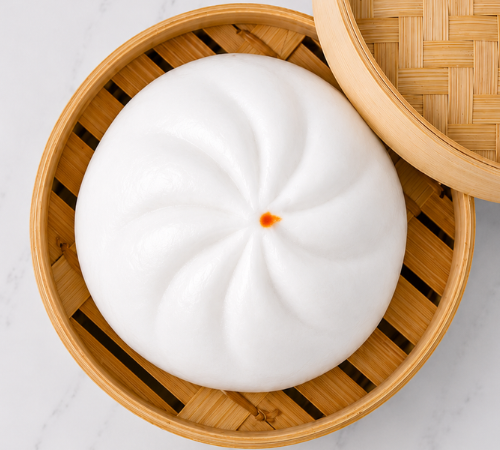 Jumbo Bola-bola Siopao served in an open bamboo steamer basket.