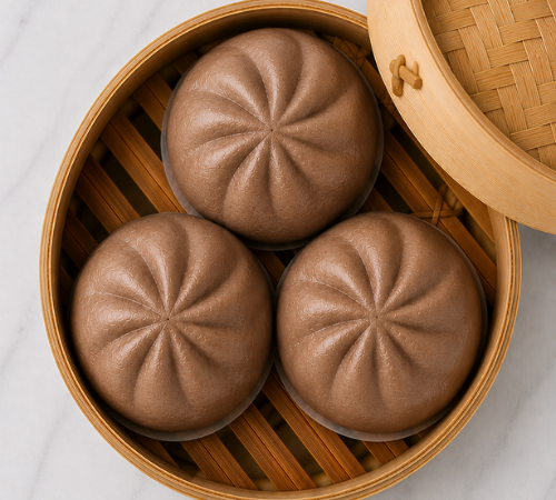 Mini Choco Siopao served in an open bamboo steamer basket.